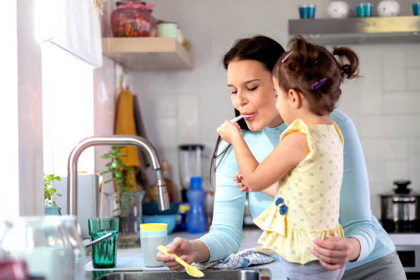 istock Mother and daughter in kitchen 1376125636
