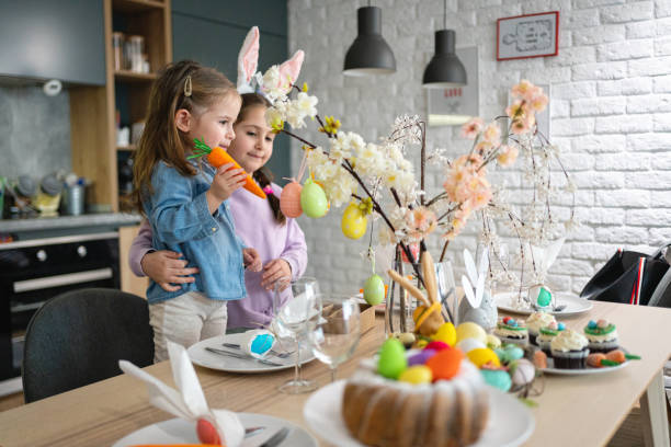 istock Excited Caucasian sisters, decorating the table for an Easter lunch 1376125925