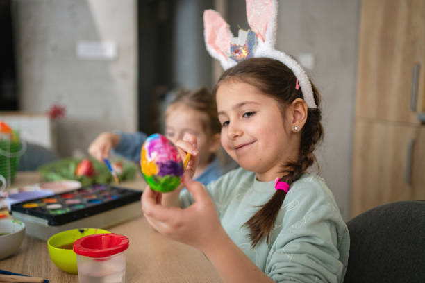 istock Creative girl, showing how she painted and decorated the egg for Easter holiday 1376126099
