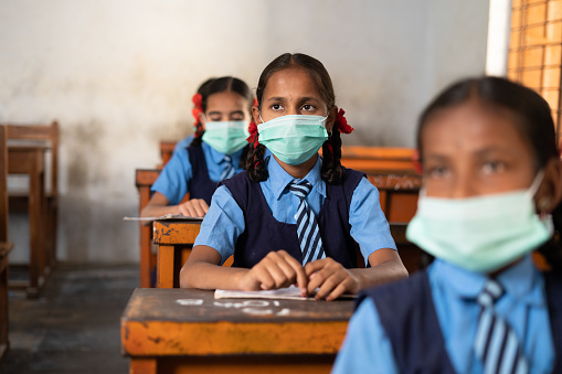Girl Kid With Medical Face Mask Listening Class At School While
