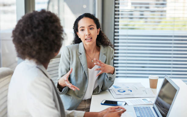Shot of two businesswomen having a discussion in an office stock photo