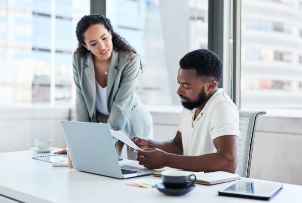 istock Shot of two businesspeople going through paperwork while working together in an office 1376141448