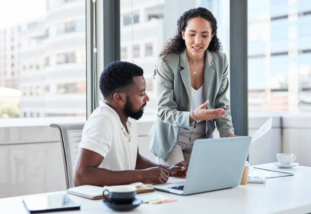 istock Shot of two businesspeople going through paperwork while working together in an office 1376141454