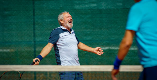 istock Senior man celebrating on tennis court 1376150749