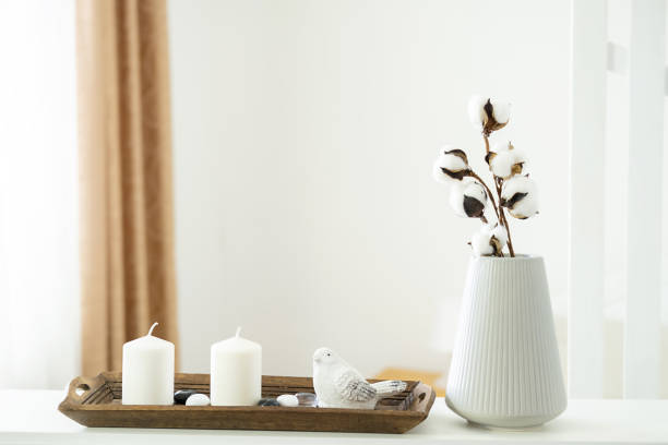 istock Minimalistic composition, harmonious interior in neutral natural colors. White scented candles with decorative elements on wooden tray. Concept of home comfort and aromatherapy. 1376162489