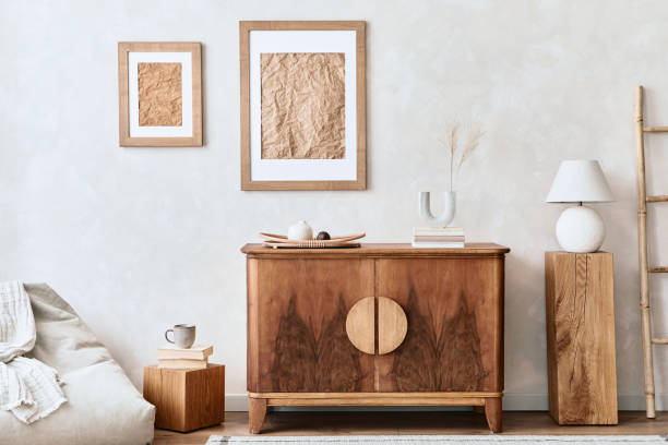 istock Interior design of neutral living room with stylish retro commode, mock up poster frame, cube, table lamp, decoration and elegant personal accessories in home decor. Template. Japandi concept.