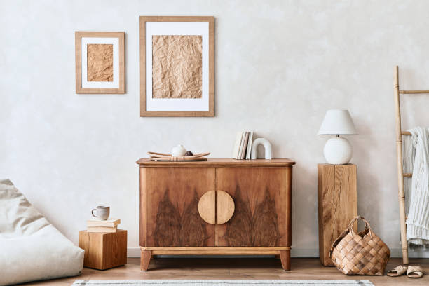 istock Interior design of neutral living room with stylish retro commode, mock up poster frame, cube, table lamp, decoration and elegant personal accessories in home decor. Template. Japandi concept.