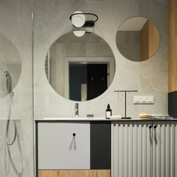 istock Stylish composition of modern bathroom interior. Designed shower, mixed wood commode, mirror and personal accessories. Walls with black and wooden panels. Minimalistic masculine concept. Template. 1376168254