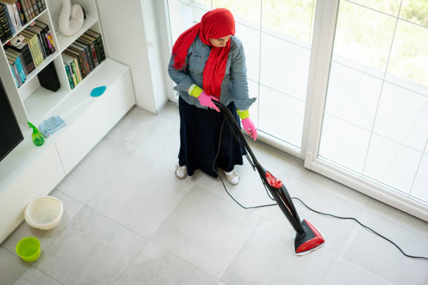 Happy Muslim Woman Cleaning Modern House Living Room stock photo