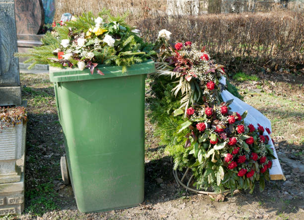 Trash can and flowers in the public cemetery