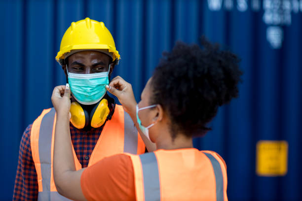 istock Wife puts a medical mask on her husband before work. Coronavirus, illness, infection, quarantine, medical mask, COVID19. Couples wear facemask before work during coronavirus, flu outbreak. 1376186546