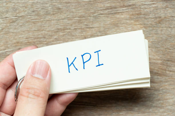 istock Man hold the flash card with handwriting word KPI (Abbreviation of key performance indicator) on wood background 1376187272