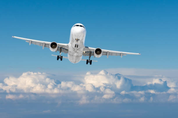 istock Airplane flight with landing gear extended against the sky. 1376192498