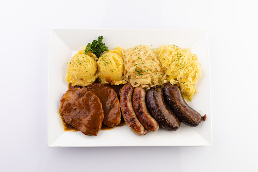 Sausages and Sauerkraut with potato in white.