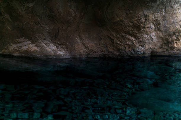 clean underground cave river in steep stone banks in the dark