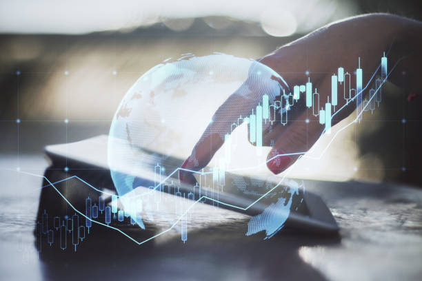 istock Close up of female hand using tablet at desktop with forex chart on blurry background with grid. Trade, finance and market concept. Double exposure. 1376203294