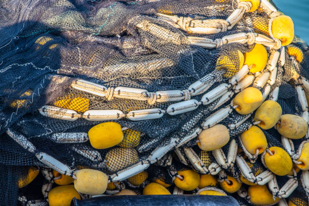 A fishing net with ropes and cord on the deck of a Fisherman's boat