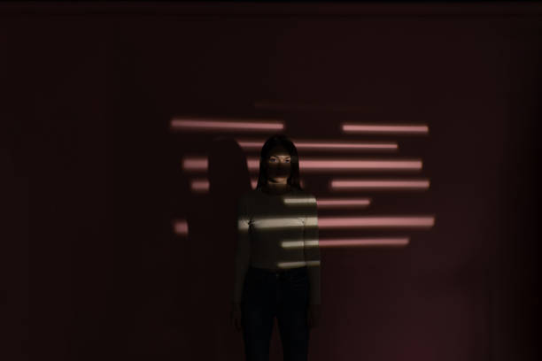 istock Woman in the shadows 1376252185
