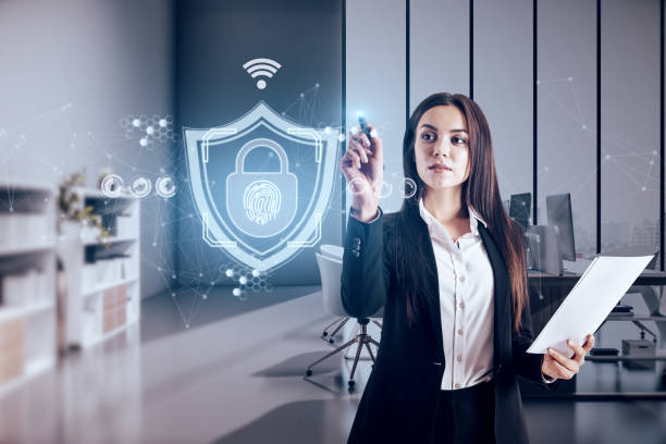 Attractive young european businesswoman with abstract web protection and thumbprint id safety hologram on blurry office interior background. Software and cybersecurity concept. Double exposure. stock photo