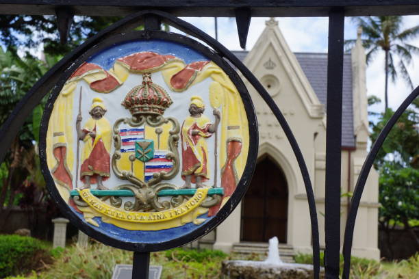 Great Seal of Hawaii with the tomb of King Lunalilo in the background in downtown Honolulu, Hawaii, USA.