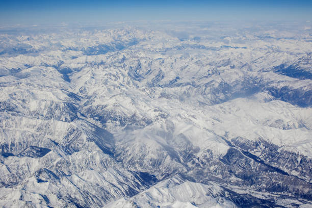 istock Panoramic view of snowy Alps from above, view from airplane window 1376265107