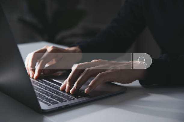 istock Search icon, Businessman use laptop computer searching information in office 1376275203