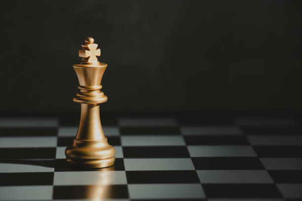 Golden chess kings standing on a board. stock photo