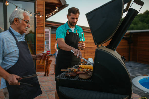 istock Senior father and son grilling meat and drinking beer in the backyard 1376317092
