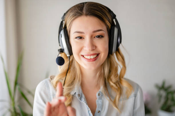 istock Young beautiful business woman with headset communicating over the internet 1376329156