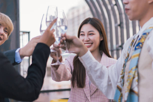 istock Young business people toasting with each other and smiling while standing on rooftops 1376347050