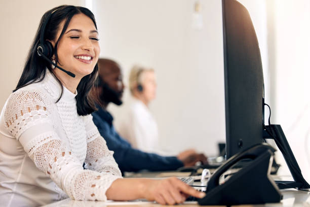 istock Shot of a young call centre agent using a telephone while working on a computer in an office 1376355635
