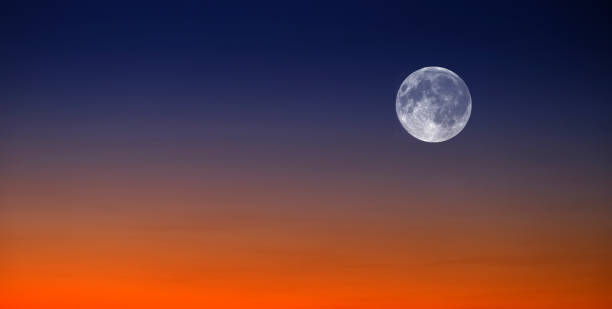 istock Sunset and Full Moon at Sunset or Sunrise on Horizon Orange and Blue Light 1376358865