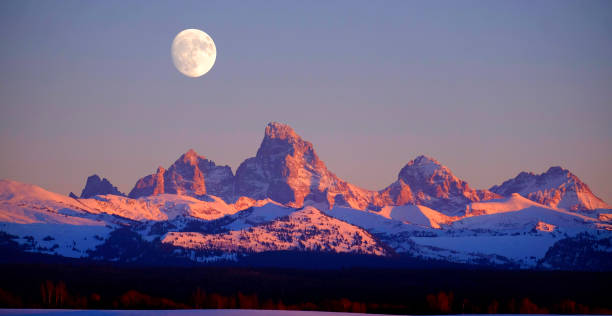 istock Sunset Light Alpen Glow on Tetons Teton Mountains wtih Moon Rising 1376358887