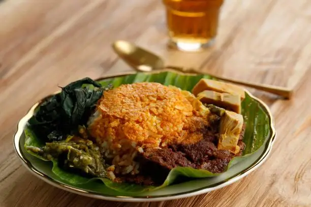 Nasi Padang, originated from Indonesia. Rice with beef Rendang, cassava leaves, Gulai Nangka,  and Sambal served on banana leaf.