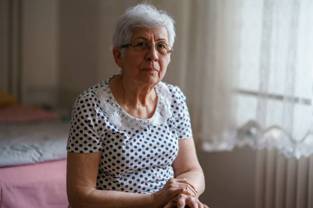 istock Senior Woman Sitting on her Bed 1376404670