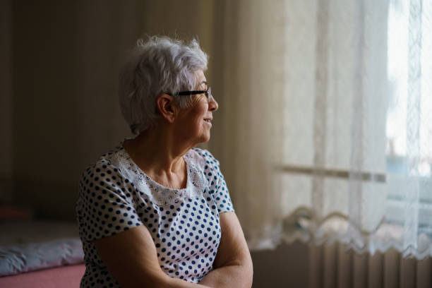 istock Senior Woman Sitting on her Bed 1376404684
