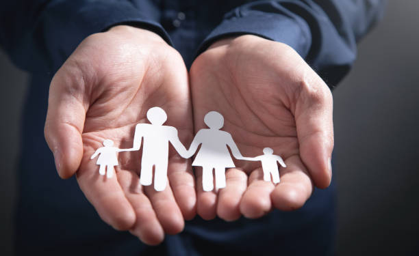 istock Human hands showing paper cut family. 1376404759