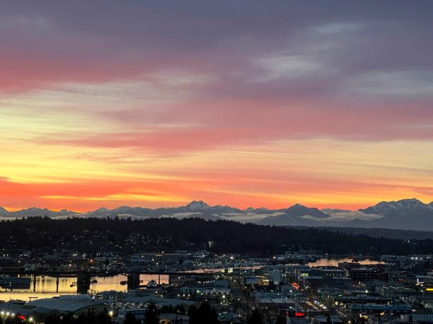 Sunset over the Olympic Mountains and Ballard in Seattle Sunset over the Olympic Mountains and Ballard in Seattle in Seattle, Washington, United States ballard-seattle stock pictures, royalty-free photos & images