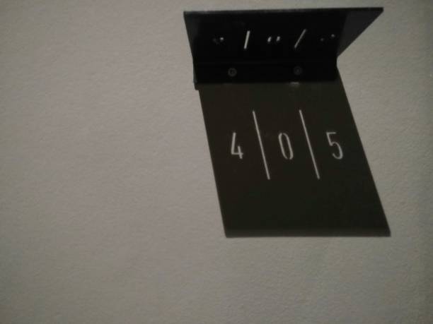 istock Name plate sign/ room number 405 on white wall ((A figure that is caused by reflections of light.) 1376413819