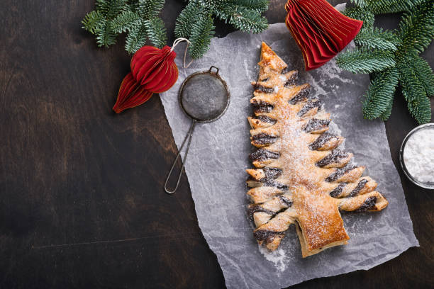 istock Puff pastry Christmas tree with chocolate paste, sprinkled with powdered sugar on old dark wooden background. Christmas or Xmas pastries. Top view. Copy Space 1376426003