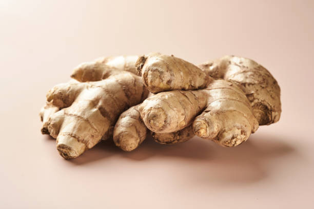 istock Ginger root. Fresh ginger root on a beige background. Vitamins. Virus-protecting products. Top view. Free space for your text. 1376429338