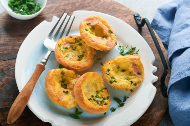 istock Egg muffins with green onions, bacon, cheese and tomatoes on white plate on light background. Healthy high protein and low carb breakfast, ready to eat. 1376444764