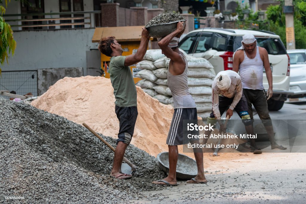 Labourer In Construction Labour Working At Construction Site Stock Photo - Download Image Now ...