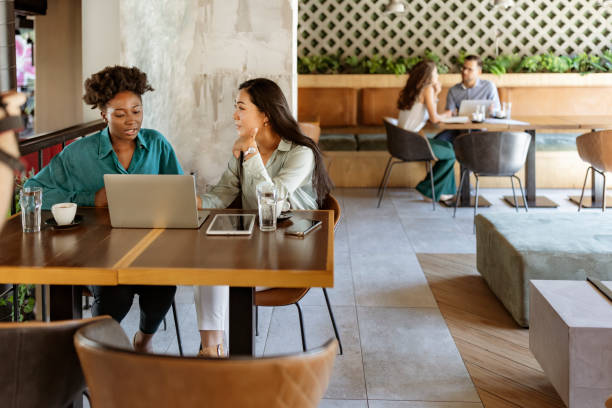 Productivity and teamwork Multiracial business team having a meeting in a coffee shop business lunch stock pictures, royalty-free photos & images