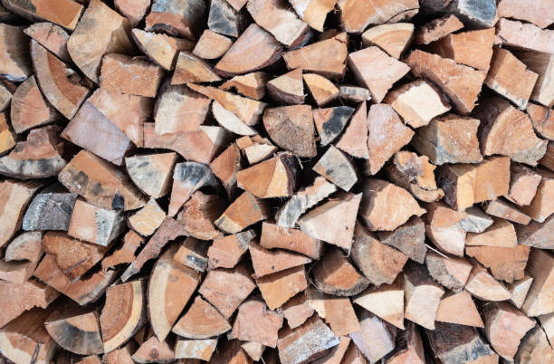 istock Stack of firewood. Chopped wood logs background. 1376477235