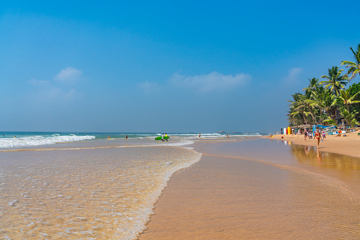 HIKKADUWA, SRI LANKA - JANUARY 22, 2014:Narigama beach at Hikkaduwa with surfer in the background