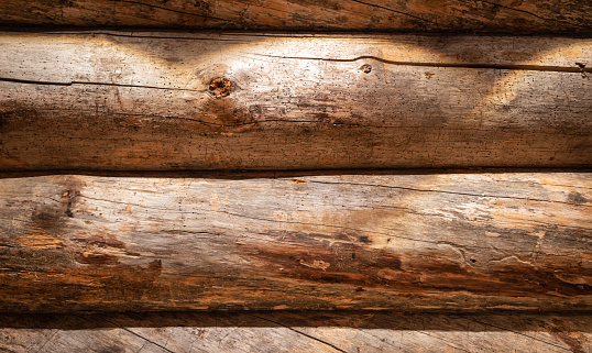 Horizontal brown wooden beams used for rustic sauna wall in Finland. Full frame.