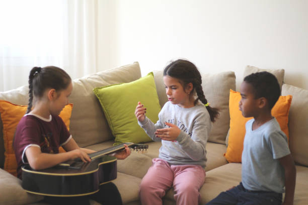 istock three different color kids are playing together in a room 1376496780