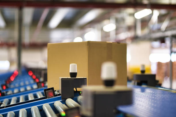 istock Cardboard boxes on conveyor belt at distribution warehouse 1376503123