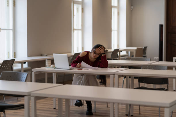 istock Asian student girl feeling tired and unmotivated while studying in university library 1376511064